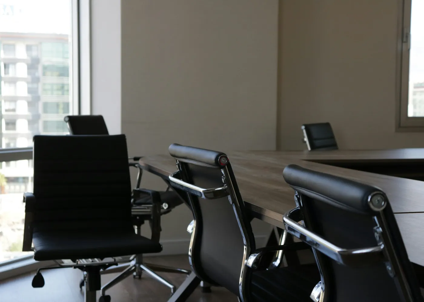 A quiet boardroom with leather chairs